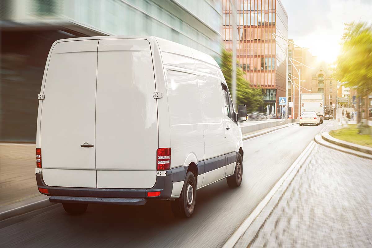 Weißer Transporter auf dem Weg zur Lieferung einer Küche